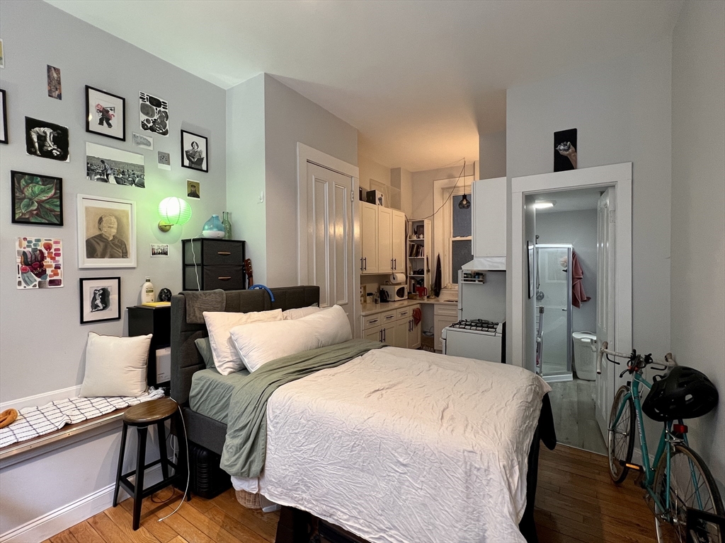 83 West Cedar Street, Unit 1 Boston, MA 02114 - Photo 1 of 15 a bedroom with a bed and a desk