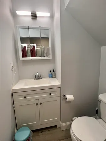 a bathroom with a sink mirror vanity and toilet
