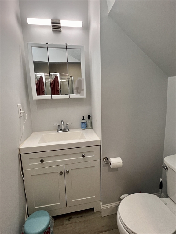 83 West Cedar Street, Unit 1 Boston, MA 02114 - Photo 13 of 15 a bathroom with a sink mirror vanity and toilet