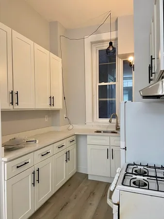 a kitchen with a sink stove and cabinets
