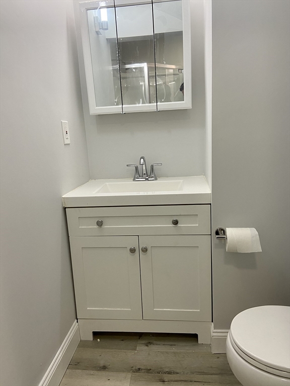 83 West Cedar Street, Unit 1 Boston, MA 02114 - Photo 15 of 15 a bathroom with a sink a toilet and a mirror