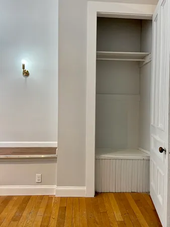 a view of walk in closet with empty racks