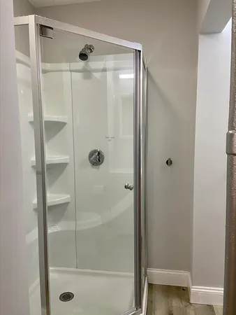 a bathroom with a glass shower door