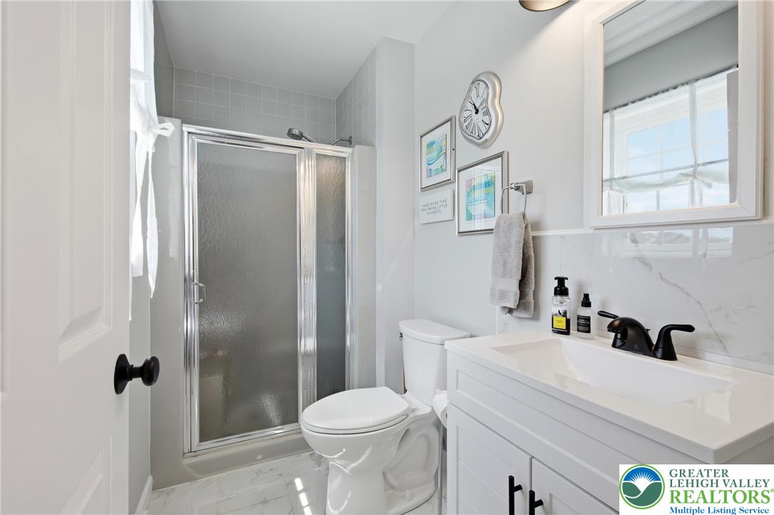 890 Lahr Road Nazareth, PA 18064 - Photo 32 of 71 A well-lit bathroom features a spacious shower and a vanity with modern fixtures.