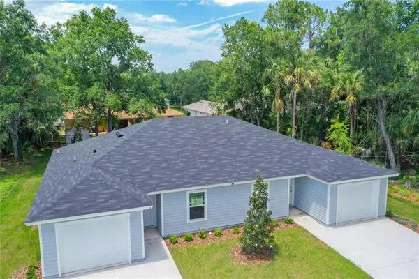 a aerial view of a house with a yard