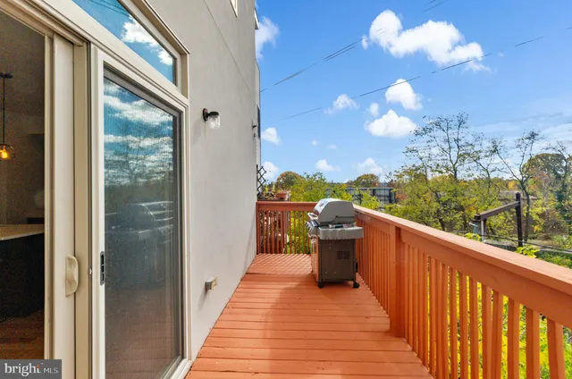 a kitchen with stainless steel appliances granite countertop a stove top oven a sink dishwasher a dining table and chairs with wooden floor