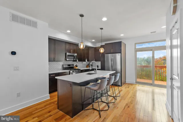 a kitchen with stainless steel appliances a refrigerator stove and sink