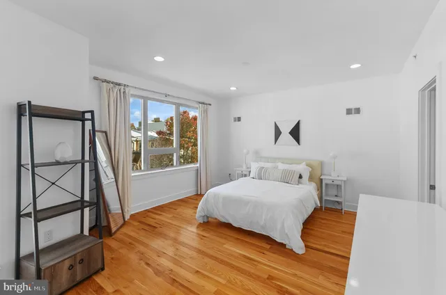 a bed room with a bed and a dresser