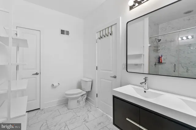 a view of a room with a ceiling fan