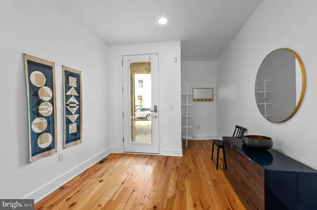 a view of an entryway with wooden floor
