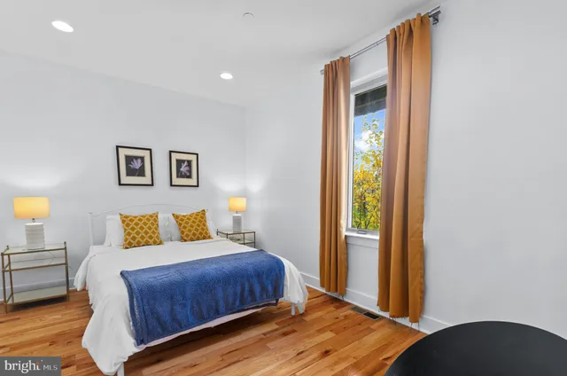 a bedroom with a bed and a lamp