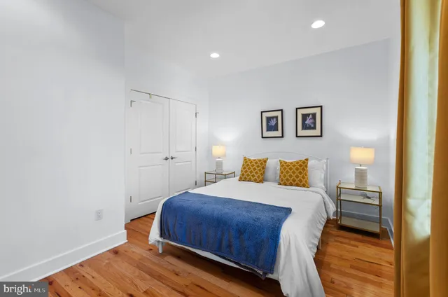 a bedroom with a bed and a wall painting