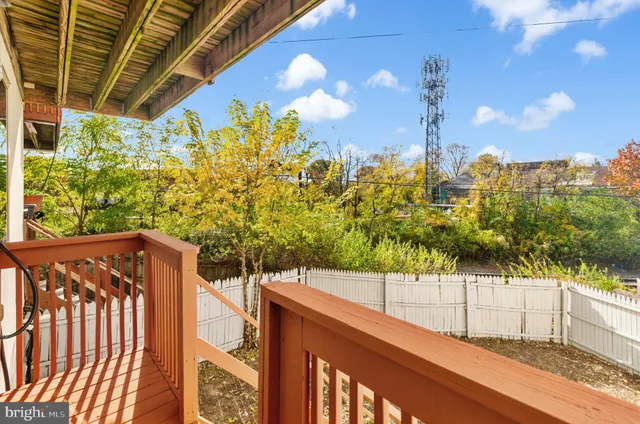 a view of a balcony with wooden fence