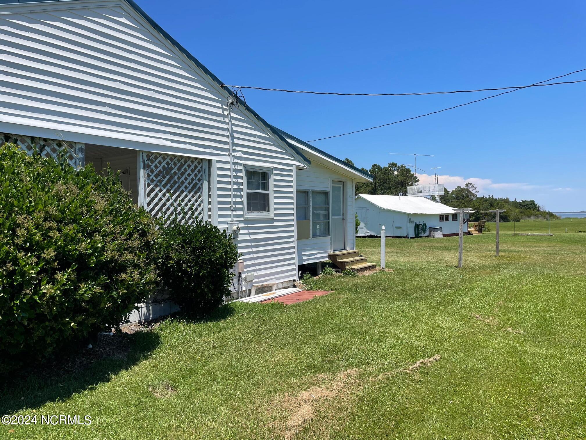 2604 Cedar Island Road Cedar Island, NC 28520 - Photo 13 of 62 Carport and side of house
