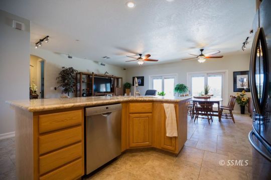 2401 Lacey Street Ridgecrest, CA 93555 - Photo 13 of 44 a kitchen with lots of counter and chairs
