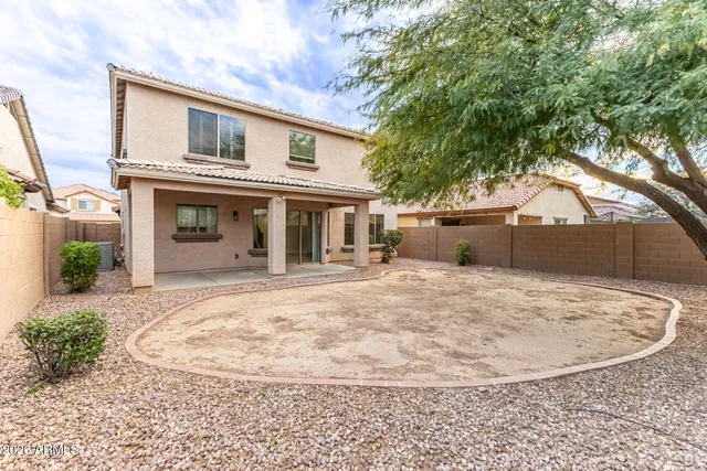 a white house that has a tree in front of it