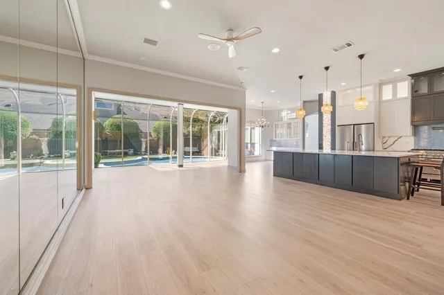 a large kitchen with stainless steel appliances kitchen island a large counter top and a sink