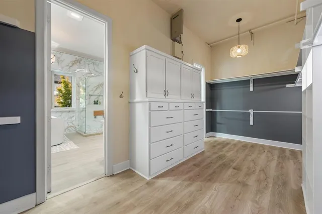 a living room with a couch and chandelier