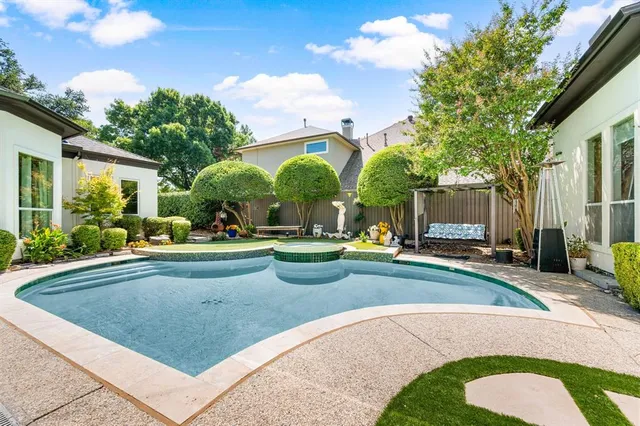 a view of a house with swimming pool and sitting area