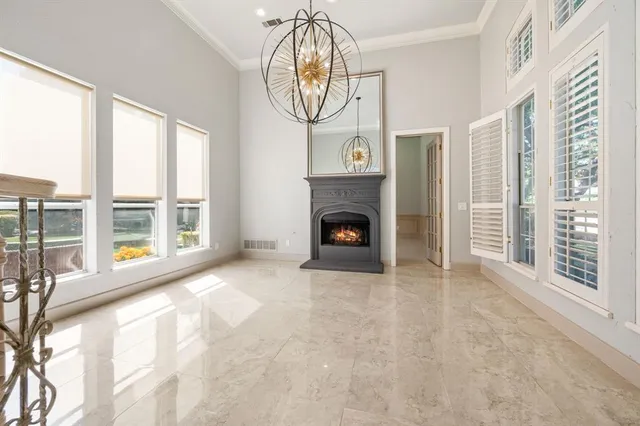 a view of an empty room with a fireplace and a window