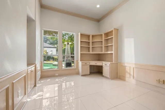 a view of an empty room with a fireplace and a window