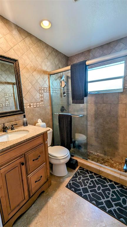8105 Nutmeg Way Tamarac, FL 33321 - Photo 16 of 28 a bathroom with a toilet a sink a shower a mirror and a sink
