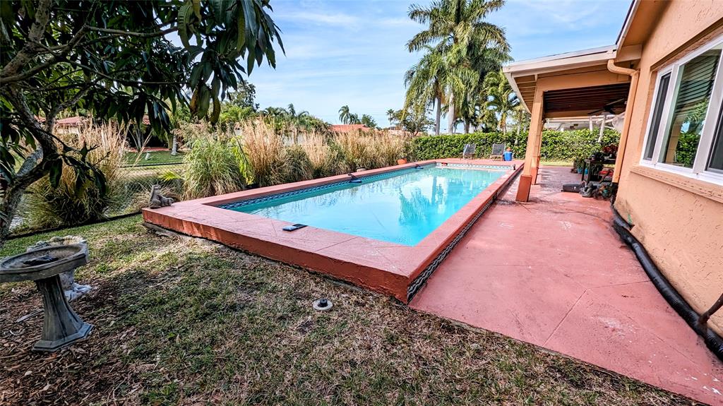 8105 Nutmeg Way Tamarac, FL 33321 - Photo 23 of 28 a view of a backyard with swimming pool