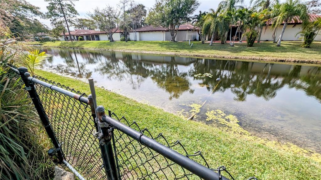 8105 Nutmeg Way Tamarac, FL 33321 - Photo 26 of 28 a view of a lake with a house in the background