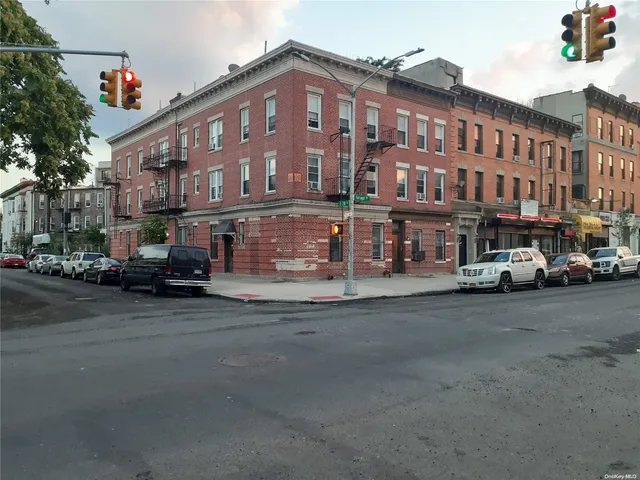 a view of a street that has couple of cars parked on the road