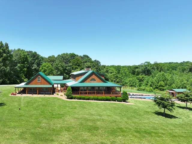 a view of house with yard and green space