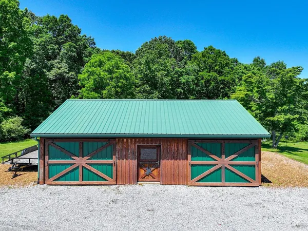 an aerial view of house with deck and outdoor space