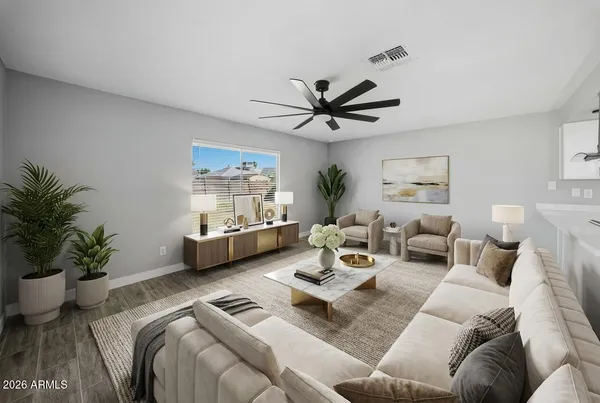 a living room with furniture a couch and a potted plant