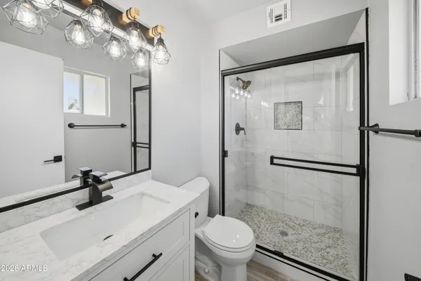 a bathroom with a sink toilet and shower