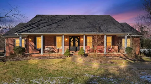 a front view of house with outdoor seating and mountain view in back