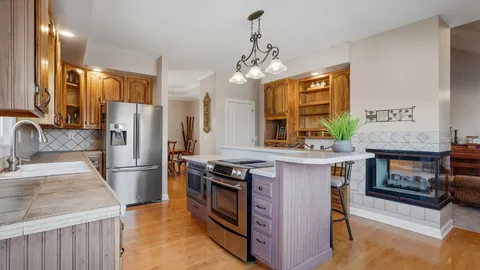 a kitchen with stainless steel appliances granite countertop a refrigerator and a sink