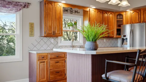 a view of a dining room with furniture a chandelier and wooden floor