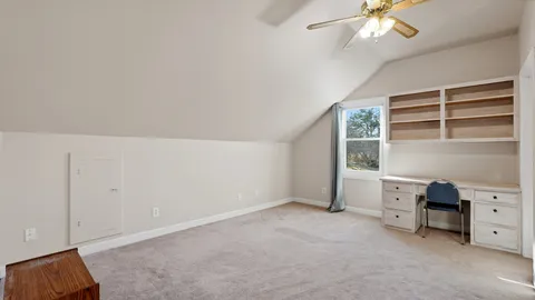 a bedroom with a bed and a chair