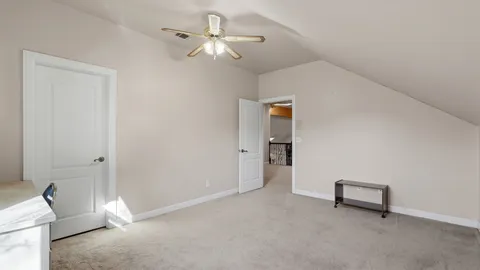 a bedroom with a bed and a television