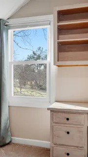 a bathroom with a sink a mirror and a window