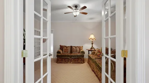 a living room with furniture and a chandelier