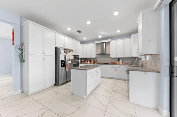 a kitchen with white cabinets and white stainless steel appliances