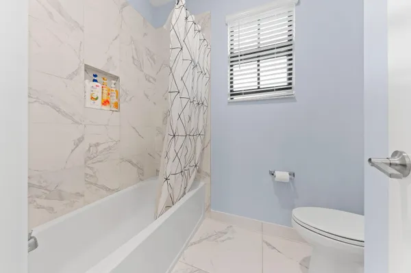 a bath room with a toilet and a bath tub