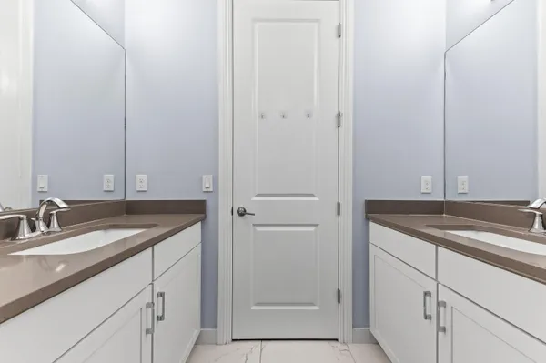 a bathroom with a granite countertop sink and mirror
