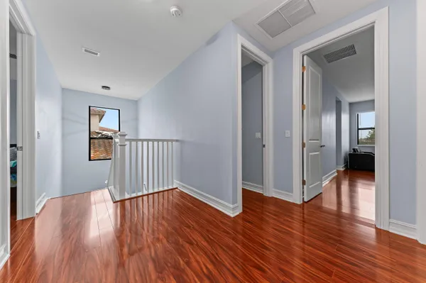 a view of a hallway with wooden floor
