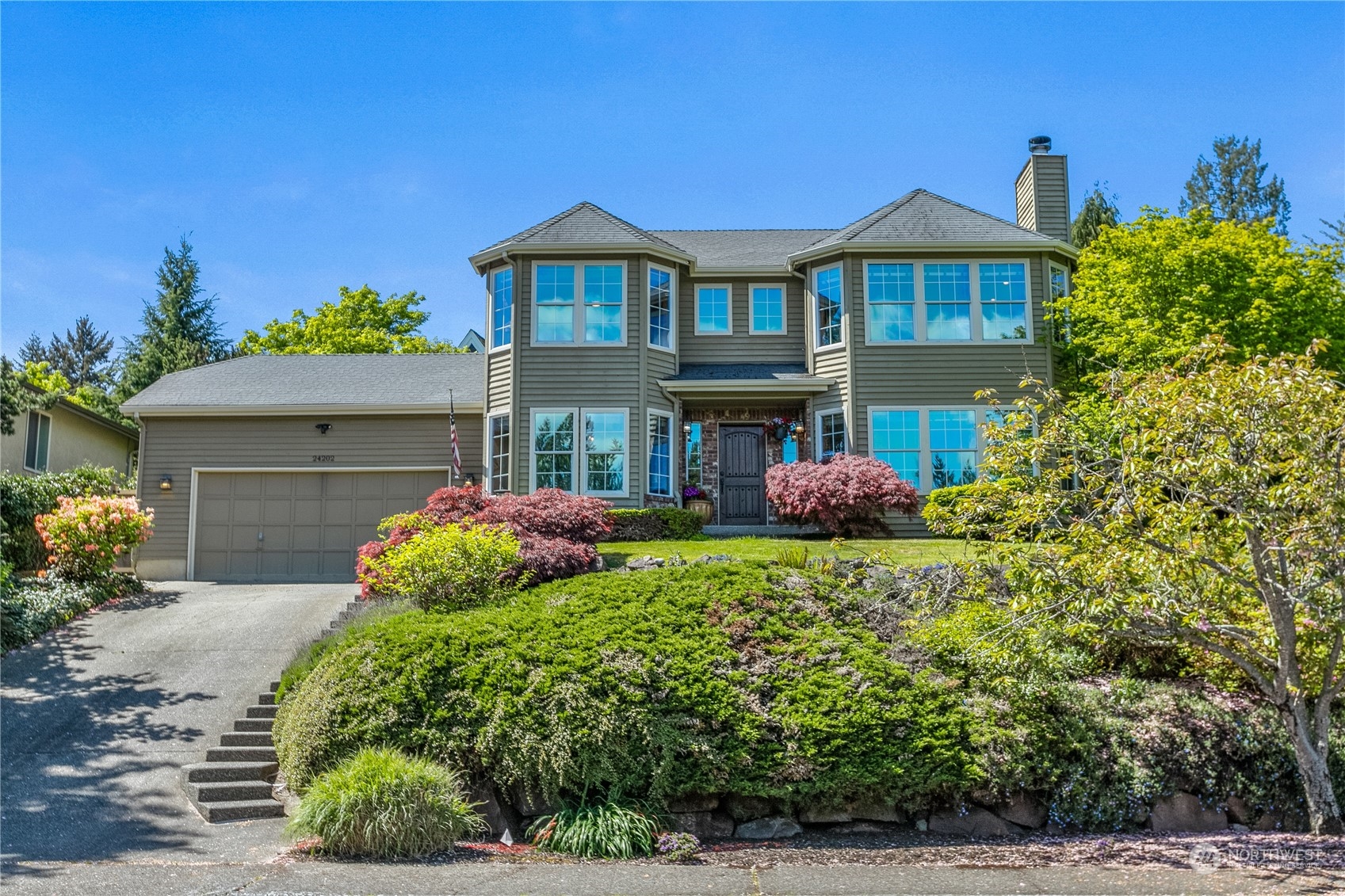 24202 26th Avenue Southeast Bothell, WA 98021 - Photo 1 of 37 a front view of a house with garden
