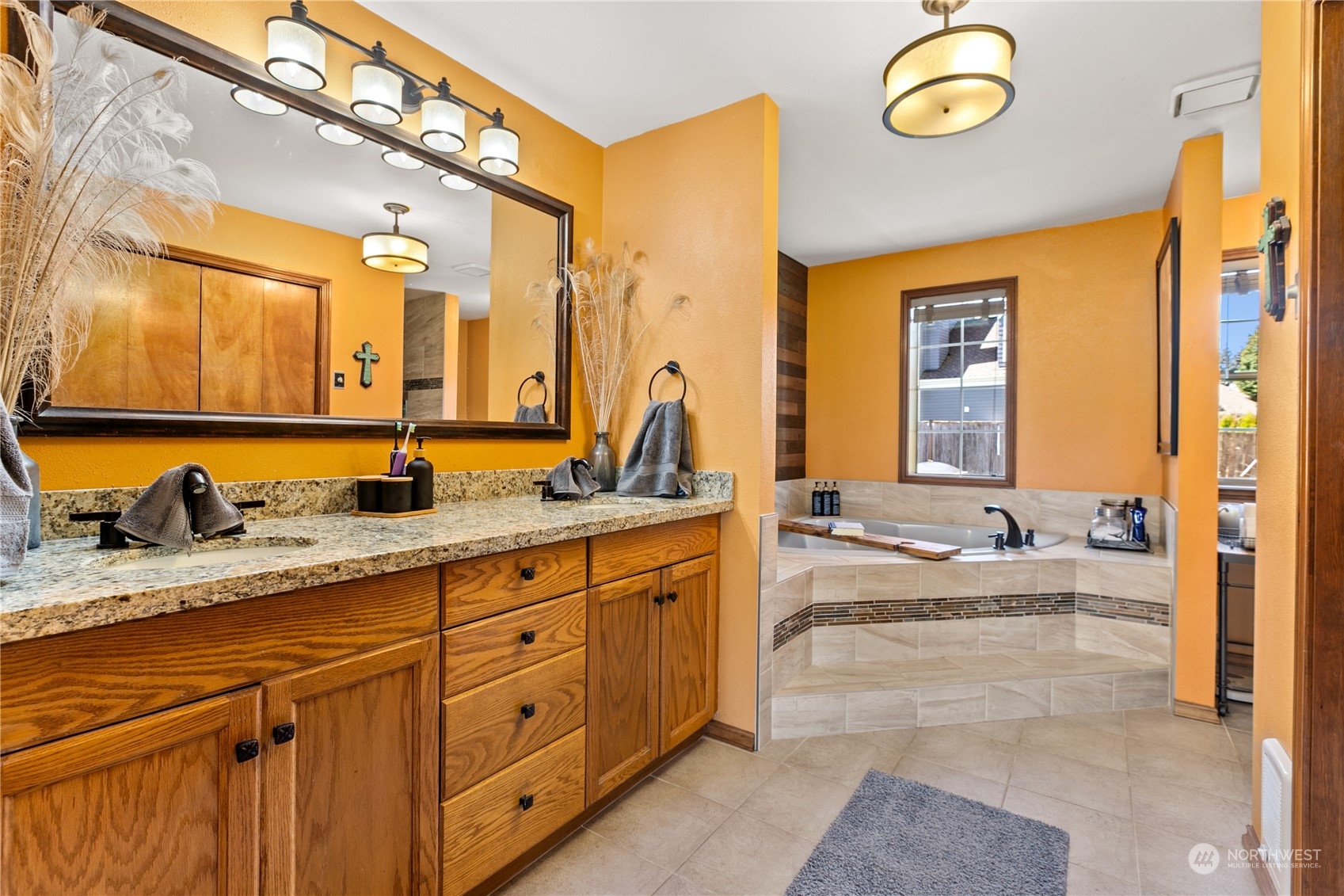 24202 26th Avenue Southeast Bothell, WA 98021 - Photo 17 of 37 a spacious bathroom with a granite countertop sink and a large mirror
