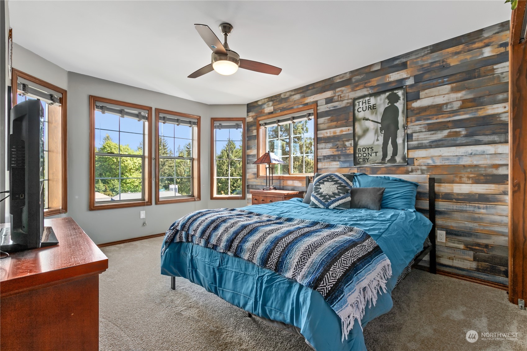 24202 26th Avenue Southeast Bothell, WA 98021 - Photo 20 of 37 a bedroom with a large bed and a flat tv screen on dresser