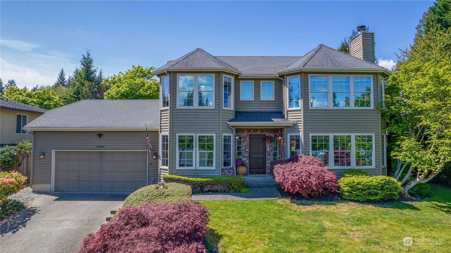 24202 26th Avenue Southeast Bothell, WA 98021 - Photo 2 of 37 a front view of a house with a garden