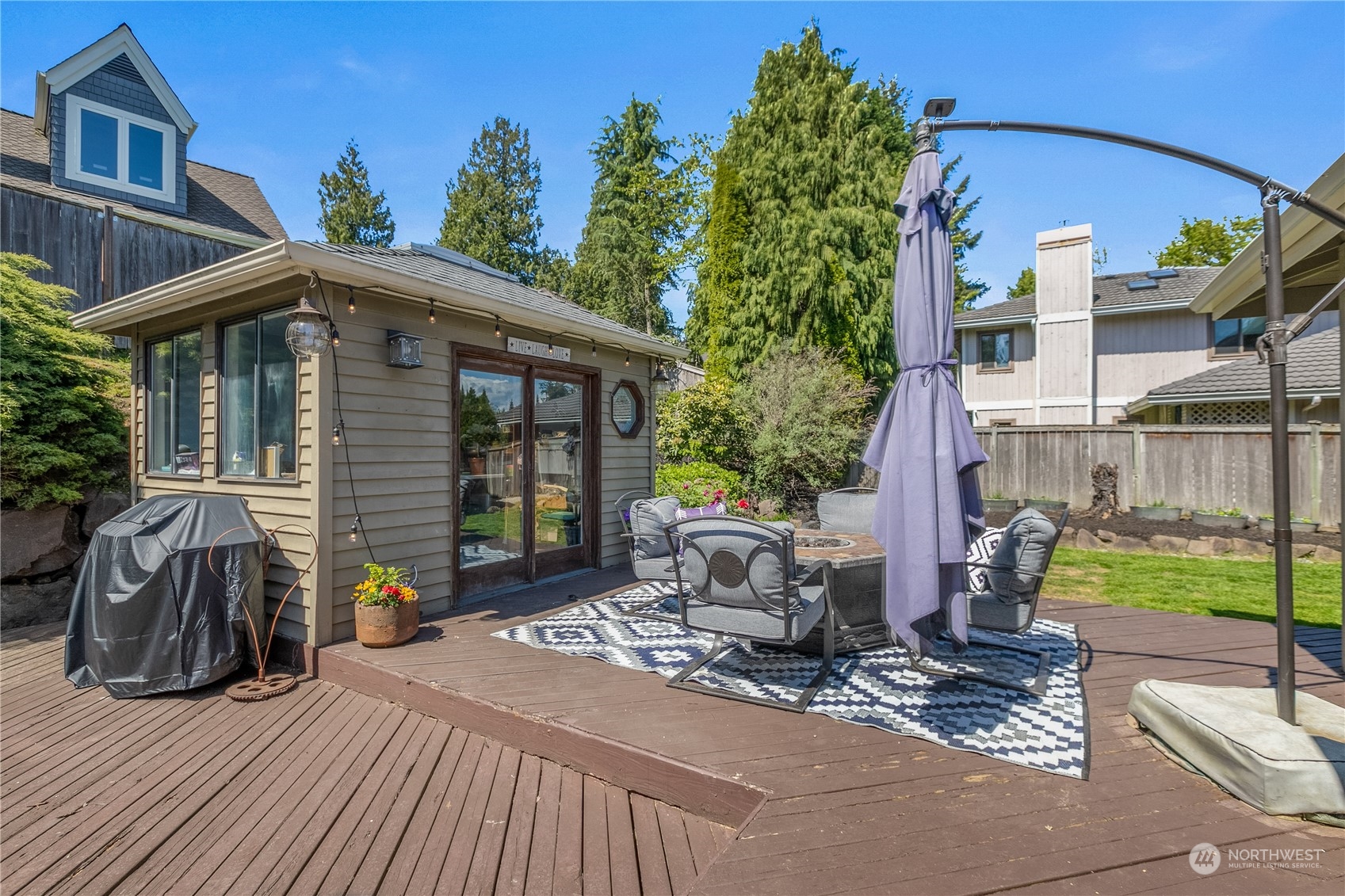 24202 26th Avenue Southeast Bothell, WA 98021 - Photo 24 of 37 a view of a patio with table and chairs with wooden floor and fence