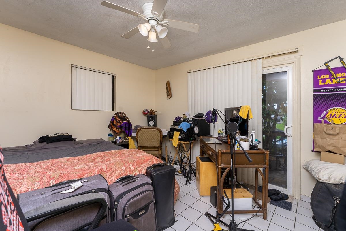 899 Kokomo Road Haiku, HI 96708 - Photo 15 of 26 a bed room with a bed mirror and a window